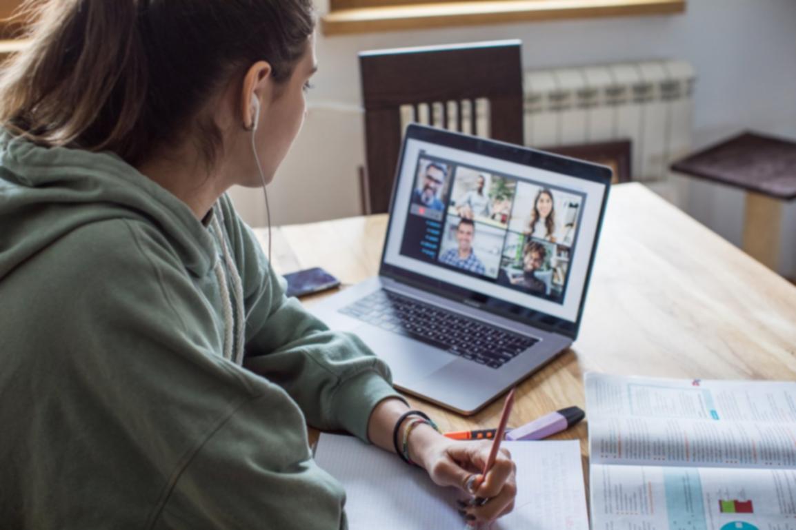 Student reviewing course materials on laptop